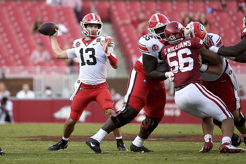 AP photo by Michael Woods / Georgia quarterback Stetson Bennett passes during the second half of Saturday's season and SEC opener against Arkansas while offensive lineman Trey Hill blocks.