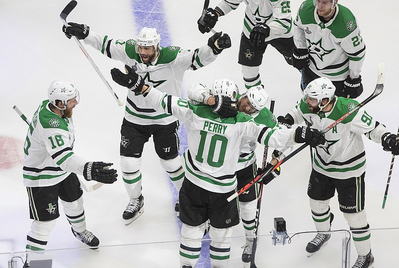AP photo by Jason Franson / Dallas Stars right wing Corey Perry (10) celebrates with his teammates after scoring against the Tampa Bay Lightning during the second overtime period of Game 5 of the Stanley Cup Final on Saturday night in Edmonton.