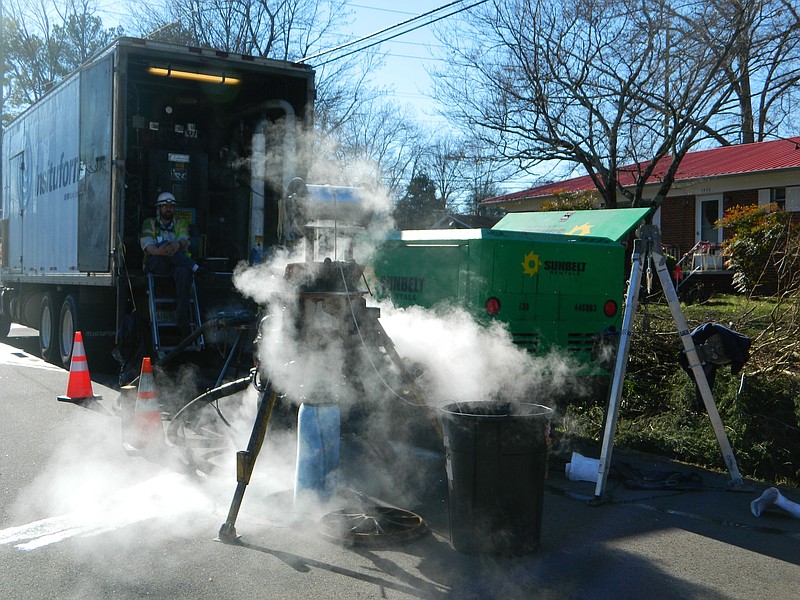 Staff file photo by Paul Leach / This photo from December 2012 shows work crews monitoring equipment blowing steam into a section of recently repaired sewer pipe under Haun Drive SW in Cleveland, Tenn. Pressurized steam is part of the curing process for resin-based pipe which adheres to the walls of the existing pipe. Cured-in-place pipe procedures essentially create a pipe within a pipe.