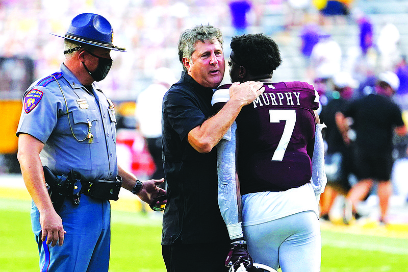 Mississippi State head coach Mike Leach hugs safety Marcus Murphy (7) after an NCAA college football game against LSU in Baton Rouge, La., Saturday, Sept. 26, 2020. Mississippi State won 44-34. (AP Photo/Gerald Herbert)