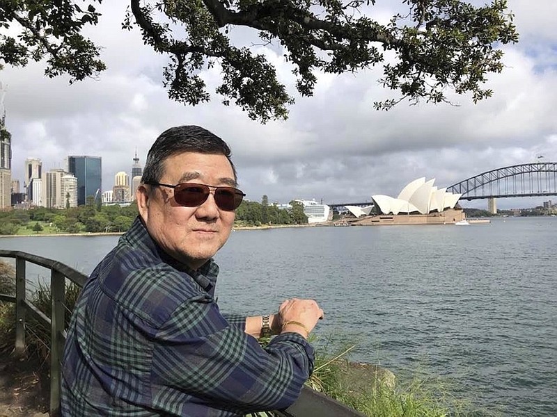 This March 2020 photo provided by the family shows Ming Wang in Sydney, Australia. The 71-year-old was sickened in March on a cruise from Australia with his wife, a break after decades of running the family's Chinese restaurant in Papillion, Neb. In the 74 days he was hospitalized, doctors desperately tried various experimental approaches, including enrolling him in a study of an antiviral drug that ultimately showed promise. Ming died on June 8. "It was just touch and go. Everything they wanted to try we said yes, do it," said his daughter, Anne Peterson. "We would give anything to have him back, but if what we and he went through would help future patients, that's what we want." (Lu Wang via AP)