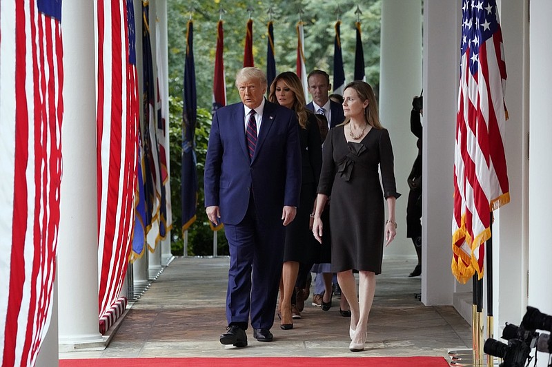 President Donald Trump walks along the Colonnade with Judge Amy Coney Barrett to a news conference to announce Barrett as his nominee to the Supreme Court, in the Rose Garden at the White House, Saturday, Sept. 26, 2020, in Washington. (AP Photo/Alex Brandon)