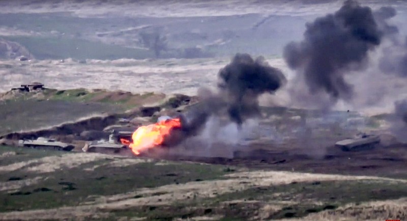 In this image taken from a footage released by Armenian Defense Ministry on Sunday, Sept. 27, 2020, Armenian forces destroy Azerbaijani military vehicle at the contact line of the self-proclaimed Republic of Nagorno-Karabakh, Azerbaijan. Fighting between Armenia and Azerbaijan has broken out around the separatist region of Nagorno-Karabakh and the Armenian Defense Ministry says two Azerbaijani helicopters have been shot down. Ministry spokeswoman Shushan Stepanyan also said Armenian forces hit three Azerbaijani tanks. (Armenian Defense Ministry via AP)