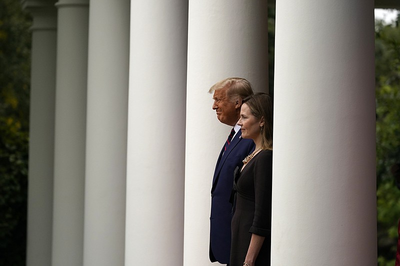 President Donald Trump walks with Judge Amy Coney Barrett to a news conference to announce the jurist as his nominee to the Supreme Court in the Rose Garden at the White House on Saturday in Washington, D.C.