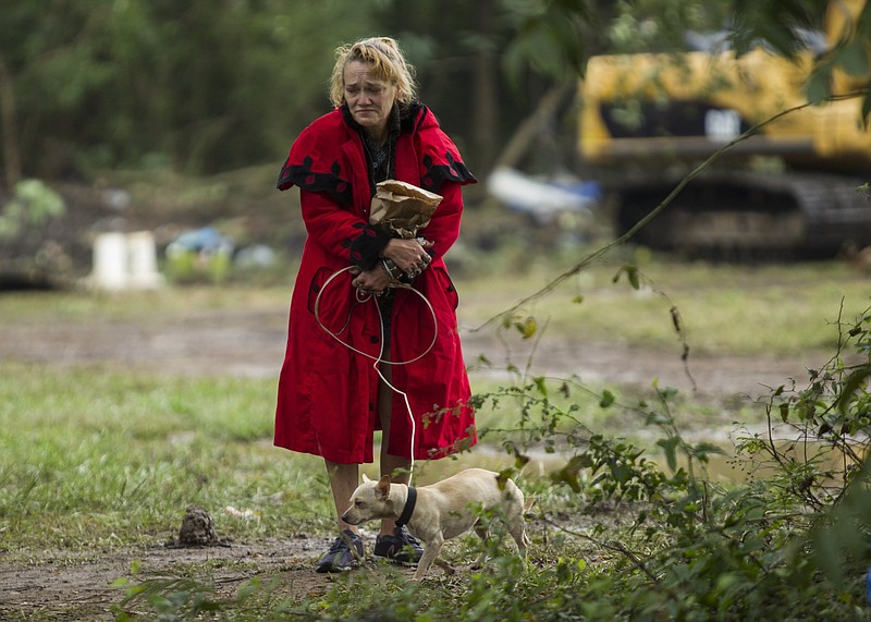 Staff photo by Troy Stolt / Patricia Rector walks with her dog Putter after being removed from a homeless encampment located off of Workman Road, where she said has been staying for 20 years, by Chattanooga Police on Tuesday, Sept. 29, 2020 in Chattanooga, Tenn. "I don't want to leave, why do they have to take my home from me?" Rector told the Times Free Press, "All they care about is money."