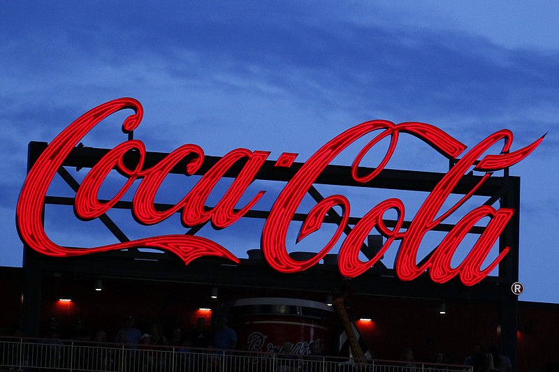 In this July 20, 2019, photo a Coca-Cola billboard is shown over left field at SunTrust Park during a baseball game between the Washington Nationals and Atlanta Braves in Atlanta. With the help of Molson Coors, Coca-Cola will start selling hard seltzer.  (AP Photo/John Bazemore, File)
