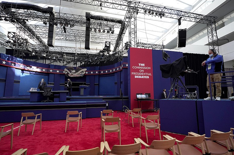 A camera operator checks his watch ahead of the first presidential debate between Republican candidate President Donald Trump and Democratic candidate former Vice President Joe Biden at the Health Education Campus of Case Western Reserve University, Tuesday, Sept. 29, 2020, in Cleveland. (AP Photo/Julio Cortez)