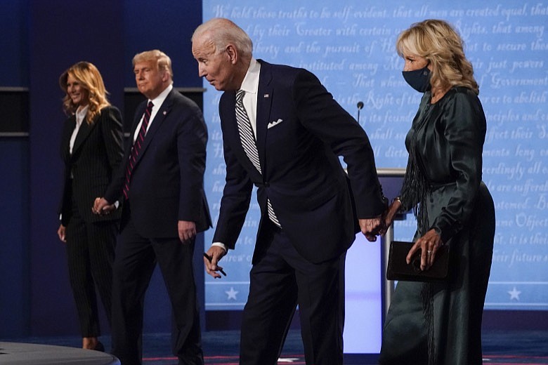 From l-r, first lady Melania Trump, President Donald Trump, Democratic presidential candidate former Vice President Joe Biden and Jill Biden, walk off stage at the conclusion of the first presidential debate Tuesday, Sept. 29, 2020, at Case Western University and Cleveland Clinic, in Cleveland, Ohio. (AP Photo/Julio Cortez)