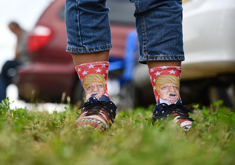 Photo by Mark Makela of The New York Times / A supporter of President Donald Trump wears Trump-themed socks and shoes ahead of a presidential debate party hosted by Vice President Mike Pence, in Lititz, Pennsylvania, on Tuesday, Sept. 29, 2020.