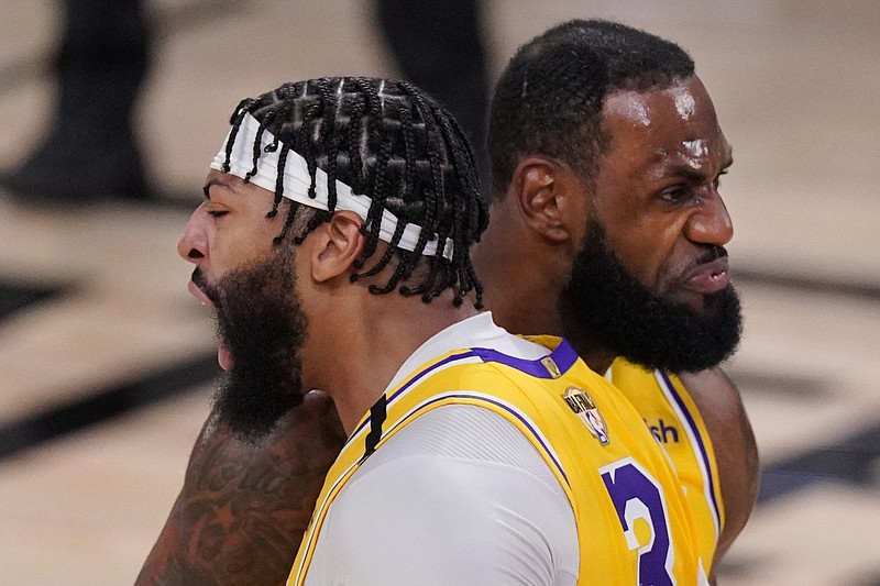 AP photo by Mark J. Terrill / Los Angeles Lakers teammates Anthony Davis, left, and LeBron James bump shoulders while celebrating a dunk during Game 1 of the NBA Finals against the Miami Heat on Wednesday night in Lake Buena Vista, Fla.