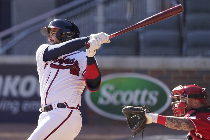 Atlanta Braves Travis d'Arnaud (16) hits a single in 12th inning against the Cincinnati Reds during Game 1 of a National League wild-card baseball series, Wednesday, Sept. 30, 2020, in Atlanta. (AP Photo/John Bazemore)