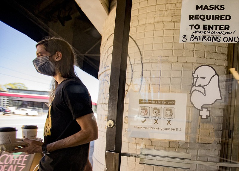 Staff photo by Troy Stolt / Wilson Kessel walks out of Mad Priest's Broad Street location after getting coffee on Friday, Oct. 2, 2020 in Chattanooga, Tenn.