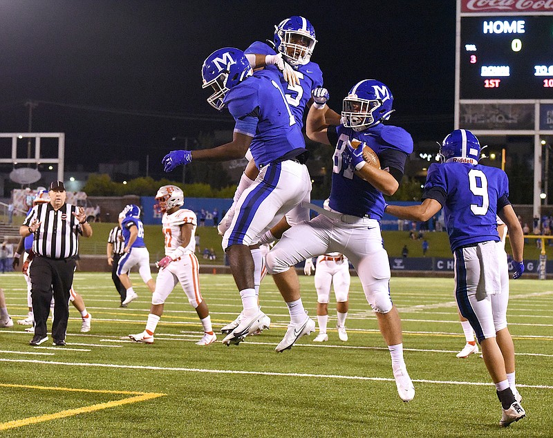 Staff photo by Matt Hamilton / McCallie's Emile Bellerose (87) celebrates with Kenzy Paul (1) and B.J. Harris (5) after making a 19-yard touchdown catch during the first half of Friday night's game against Baylor at Finley Stadium. Bellerose helped the Blue Tornado beat Baylor 33-14 to extend their series winning streak to five games.