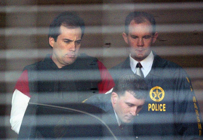 FILE - In this April 13, 2005, file photo, convicted bomber Eric Rudolph, left, is led to a waiting police car by U.S. Marshals as he leaves the Jefferson County Jail for a hearing in Birmingham, Ala. Rudolph, who was sentenced to life imprisonment after pleading guilty in the fatal bombing of an Alabama abortion clinic and the 1996 Atlanta Olympics, is arguing he deserves a new sentencing hearing or a chance to withdraw his plea. Rudolph filed a handwritten challenge in June 2020, and a public defender submitted further arguments in the case this week, WBMA-TV reported. (AP Photo/John Bazemore, File)


