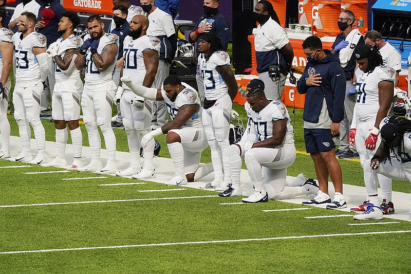 AP photo by Jim Mone / The Tennessee Titans, shown as the national anthem plays before their road game against the Minnesota Vikings on Sept. 27, continue to receive positive test results as they deal with the NFL's first COVID-19 outbreak.