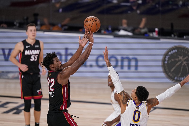 AP photo by Mark J. Terrill / The Miami Heat's Jimmy Butler shoots over the Los Angeles Lakers' Kyle Kuzma during the second half of Game 3 of the NBA Finals on Sunday night in Lake Buena Vista, Fla. Butler finished with 40 points, 13 assists and 11 rebounds, helping the Heat win 115-104 to cut the Lakers' lead in the best-of-seven series to 2-1. Game 4 is Tuesday night.