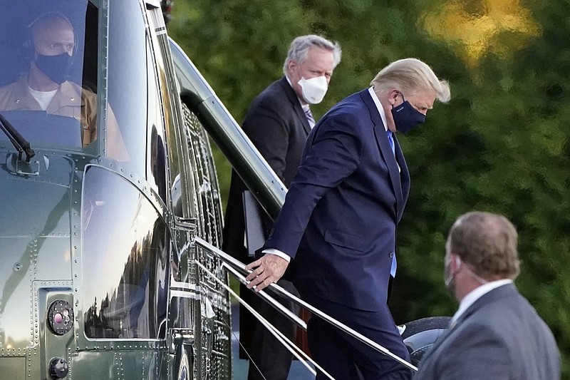 FILE - In this Friday, Oct. 2, 2020, file photo, President Donald Trump steps down from Marine One as he arrives at Walter Reed National Military Medical Center in Bethesda, Md., after he tested positive for COVID-19. White House chief of staff Mark Meadows is in the background. The president's coronavirus infection, as well as the illnesses of several aides and allies, has imperiled the highest levels of the U.S. government. The White House's efforts Saturday to project calm backfired in stunning fashion, resulting in a blizzard of confusing and contradictory information about the health and well-being of the commander in chief. (AP Photo/Jacquelyn Martin, File)