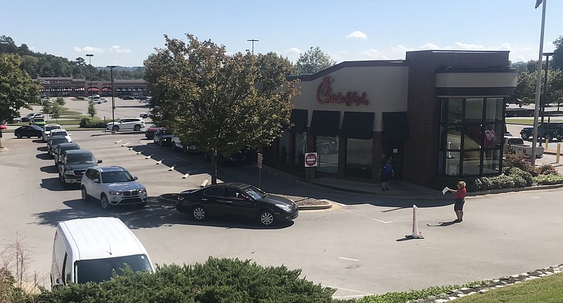 Photo by Dave Flessner / Motorists go through the drive-through at the Chick-fil-A restaurant on Highway 153 in Hixson Monday afternoon.