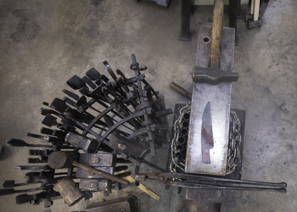 Staff photo by Troy Stolt / A piece of high carbon steel being forged into a kitchen knife is seen inside of Mak Kelsay's home, where he has a shop in his garage on Friday, Oct. 2, 2020 in Ooltewah, Tenn.