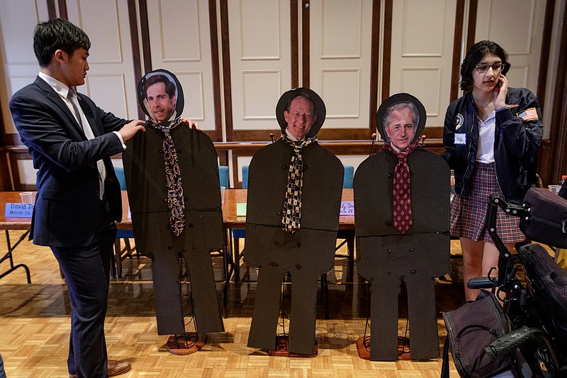 Staff file photo by Doug Strickland / Alan Liu, left, and Anika Iqbal in April 2018 set up cardboard cutouts of absent lawmakers before a town hall to discuss gun violence during a St. Paul's Episcopal Church program in Chattanooga. Chattanooga Students Leading Change hosted the town hall to discuss issues with elected officials. The absent lawmakers were Rep. Chuck Fleischmann, Sen. Lamar Alexander and then-Sen. Bob Corker.
