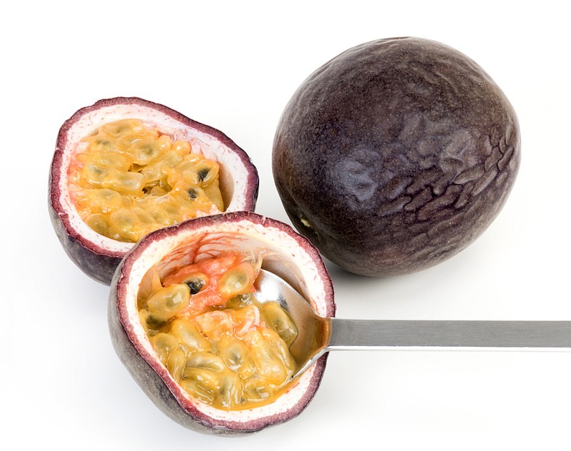 Halves of passion fruit with spoon and one whole isolated. / Photo credit: Getty Images/iStock/Josef Mohyla