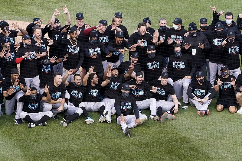 Members of the Miami Marlins celebrate after defeating the Chicago Cubs in Game 2 of a National League wild-card baseball series Friday, Oct. 2, 2020, in Chicago. The Marlins won the series 2-0 to advance to the division series. (AP Photo/Nam Y. Huh)