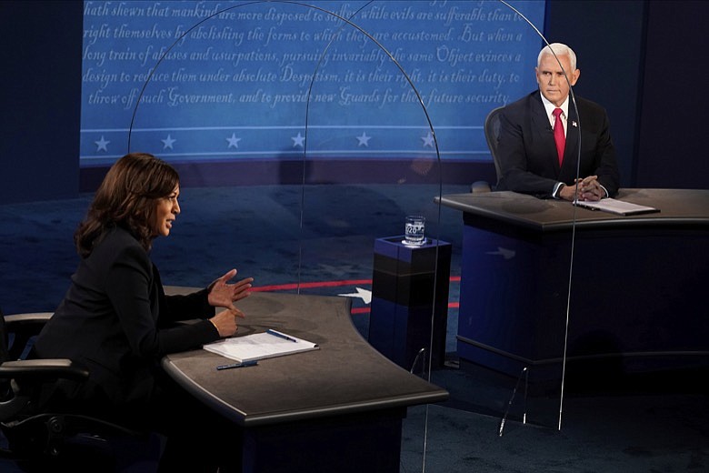 Vice President Mike Pence listens as Democratic vice presidential candidate Sen. Kamala Harris, D-Calif., answers a question during the vice presidential debate Wednesday, Oct. 7, 2020, at Kingsbury Hall on the campus of the University of Utah in Salt Lake City. (AP Photo/Morry Gash, Pool)