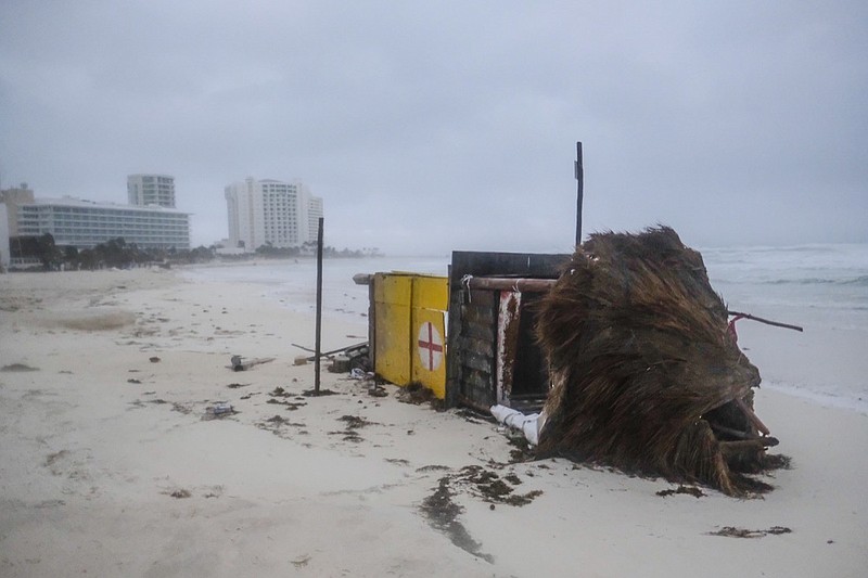 A lifeguard tower lays on its side after it was toppled over by Hurricane Delta in Cancun, Mexico, early Wednesday, Oct. 7, 2020. Hurricane Delta made landfall Wednesday just south of the Mexican resort of Cancun as a Category 2 storm, downing trees and knocking out power to some resorts along the northeastern coast of the Yucatan Peninsula. (AP Photo/Victor Ruiz Garcia)