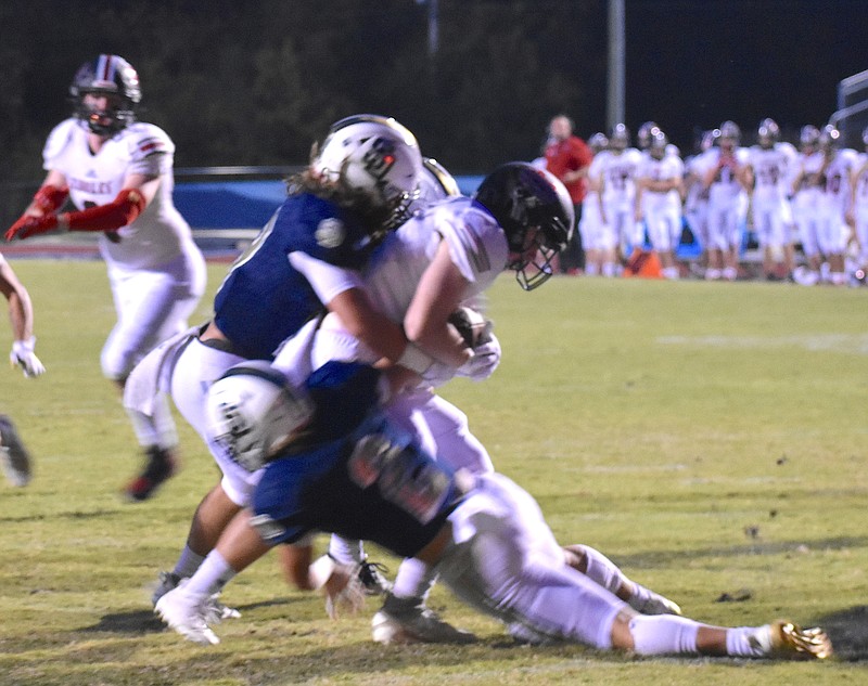 Staff photo by Patrick MacCoon / Soddy-Daisy linebackers Jonah Gipson (19) and Landon Lewis (2) make a tackle during Thursday's 31-15 win over Signal Mountain.