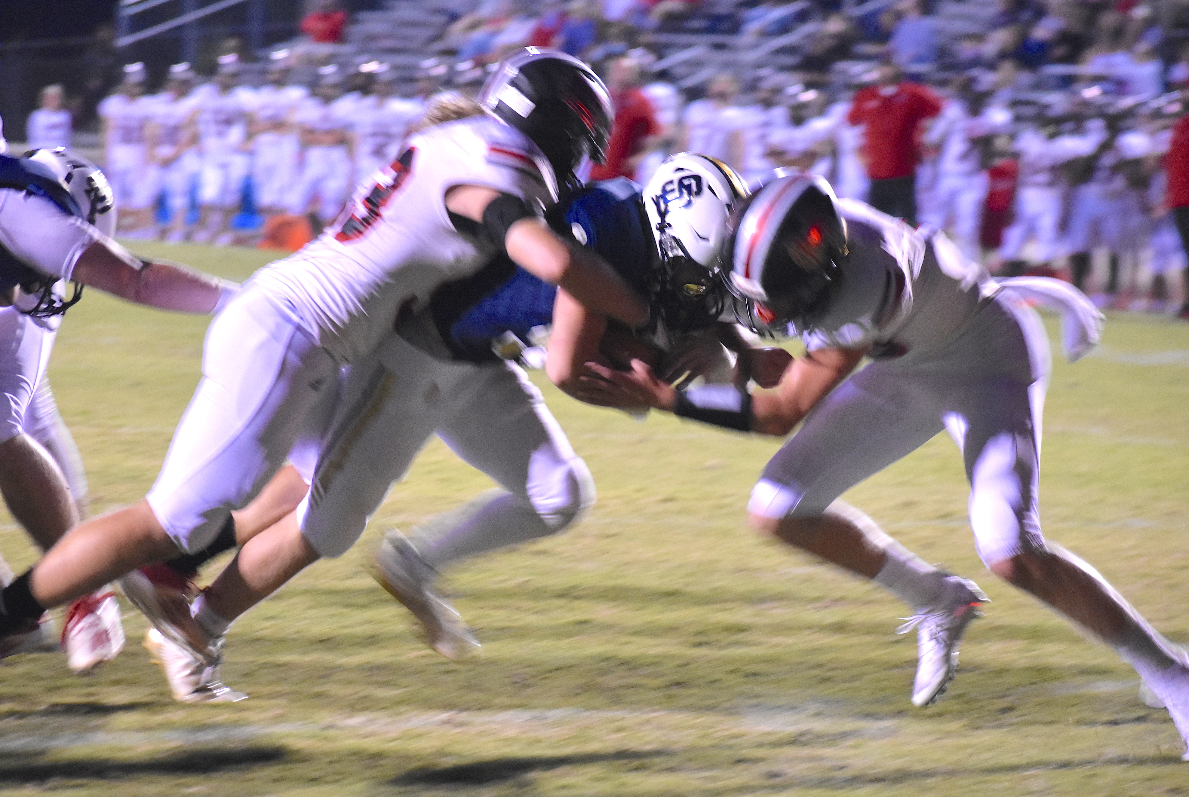 Staff photo by Patrick MacCoon / Soddy-Daisy's Tanner Whittenbarger goes through two Signal Mountain defenders for one of his two rushing touchdowns in Thursday's 31-15 home victory for the Trojans.