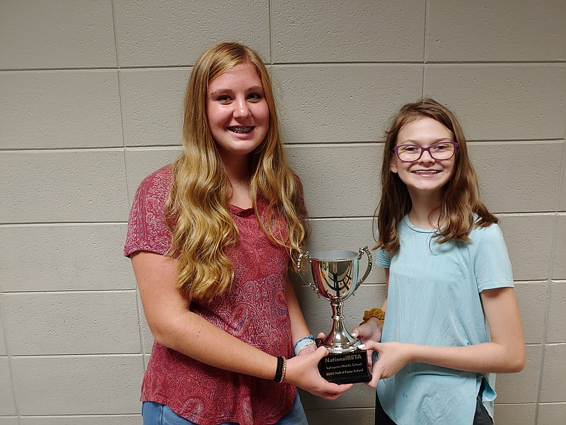 Contributed photo by Elizabeth Edwards / Ella Maples, left, and MacKenzie Nelson display the trophy for the National Beta 2020 Hall of Fame Service Award the LaFayette High School Beta club received from for its Beta Buddies service project. The girls put in the most service hours for the Beta Buddies project out of all the club members.