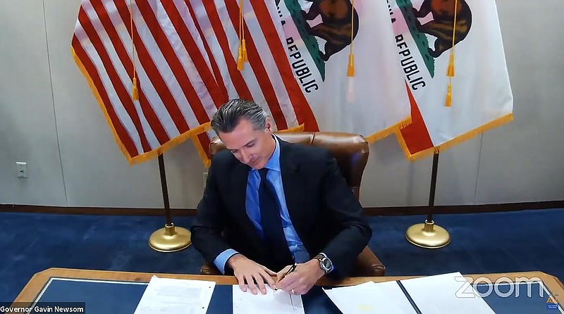 Photo from the Office of the Governor via The Associated Press / This image made from video from the Office of the Governor shows California Gov. Gavin Newsom signing into law a bill that establishes a task force to come up with recommendations on how to give reparations to Black Americans on Wednesday, Sept. 30, 2020, in Sacramento, California.