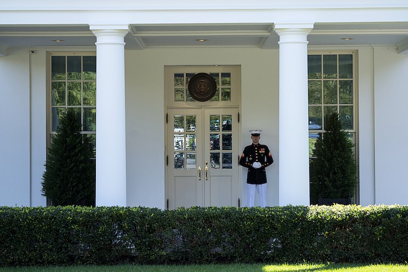 A Marine is posted outside the West Wing of the White House, signifying the President is in the Oval Office, Wednesday, Oct. 7, 2020, in Washington. (AP Photo/Evan Vucci)