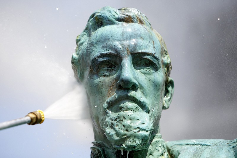 Staff photo by C.B. Schmelter / Hamilton County Engineering and Facilities Maintenance superintendent Scott Vandergriff pressure washes the bust of Confederate Lt. Gen. Alexander P. "Old A.P." Stewart outside of the Hamilton County Courthouse on Tuesday, June 2, 2020 in Chattanooga, Tenn. The statue was vandalized during protests against the killing of George Floyd.