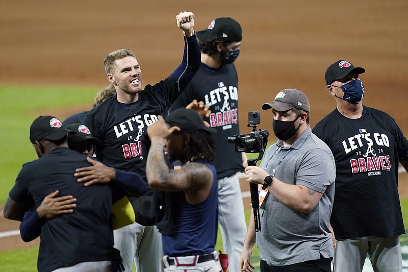 AP photo by David J. Phillip / Atlanta first baseman Freddie Freeman gestures as the Braves celebrate after beating the Miami Marlins on Thursday in Houston to sweep their NL Division Series.