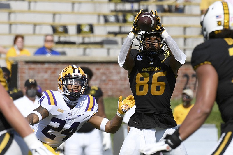 AP photo by L.G. Paterson / Missouri wide receiver Tauskie Dove catches a pass as LSU cornerback Derek Stingley Jr. comes in to make the tackle during Saturday's game in Columbia, Mo.
