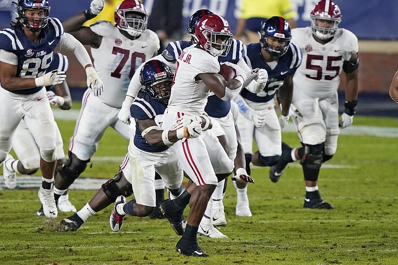AP photo by Rogelio V. Solis / Alabama running back Brian Robinson Jr. can't escape an Ole Miss defender during Saturday night's game in Oxford, Miss.