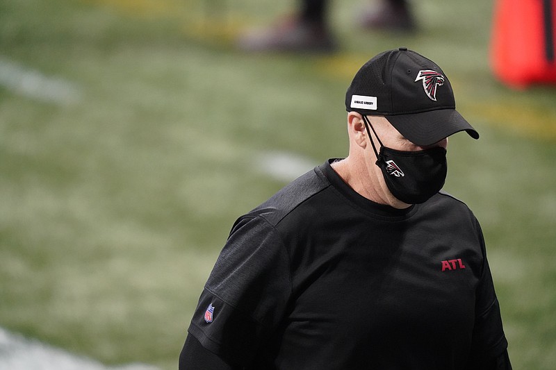 AP photo by Brynn Anderson / Atlanta Falcons coach Dan Quinn walks off the field Sunday afternoon at Mercedes-Benz Stadium. The Falcons opened their NFC South schedule with a loss to the Carolina Panthers, falling to 0-5 this season.