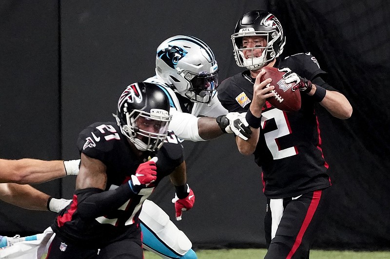 AP photo by John Bazemore / Atlanta Falcons quarterback Matt Ryan looks for a receiver under pressure during Sunday's home game against the Carolina Panthers. Ryan was 21-of-37 passing for 226 yards with no touchdowns and an interception in Atlanta's 23-16 loss, and he was sacked twice.