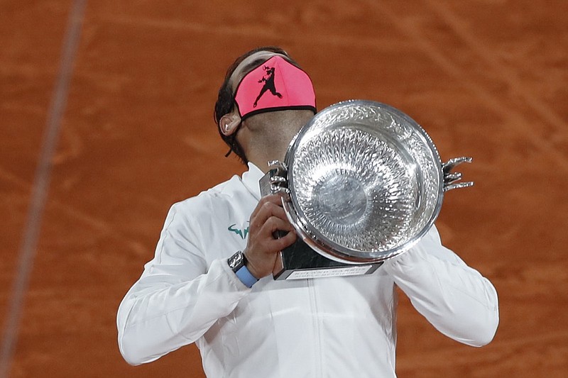 AP photo by Alessandra Tarantino / Rafael Nadal holds his trophy as he celebrates winning the French Open men's singles title against Novak Djokovic in three sets Sunday in Paris.