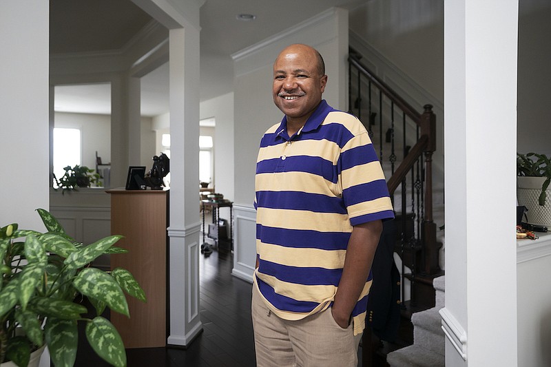 Banking executive Bob Marshall, an active stock investor, poses for a photo at his home in Ashburn, Va., Friday, Aug. 7, 2020. Nearly half of all U.S. households don't own any stocks, and a disproportionate number of them are from Black and other racial-minority households. Differences in financial-literacy education may be one factor, Marshall said. Or, because fewer Black families have wealth that has carried through generations, they may be more wary of risky investments. (AP Photo/J. Scott Applewhite)