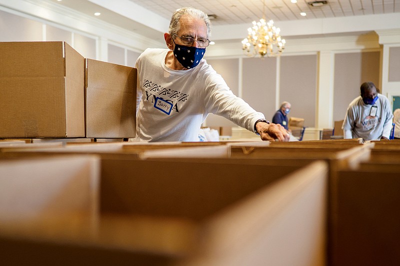 Staff photo by C.B. Schmelter / Barry Ligon helps label boxes for the Brainerd Community Food Pantry at Brainerd United Methodist Church on Tuesday, Oct. 13, 2020 in Chattanooga, Tenn. The Brainerd Community Food Pantry will hold its first distribution Wednesday, Oct. 14 at the church.