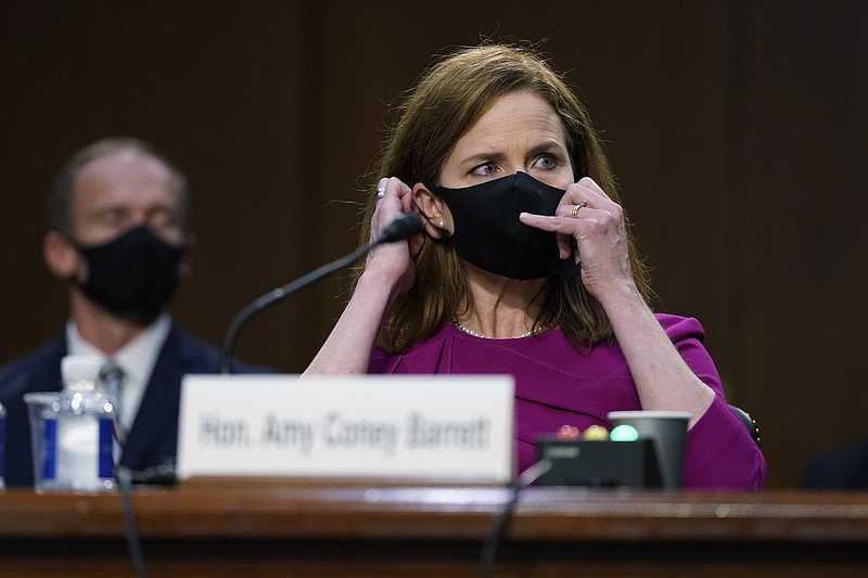 AP Photo by Patrick Semansky / Supreme Court nominee Amy Coney Barrett adjusts her mask and listens during a confirmation hearing before the Senate Judiciary Committee, Monday on Capitol Hill in Washington.
