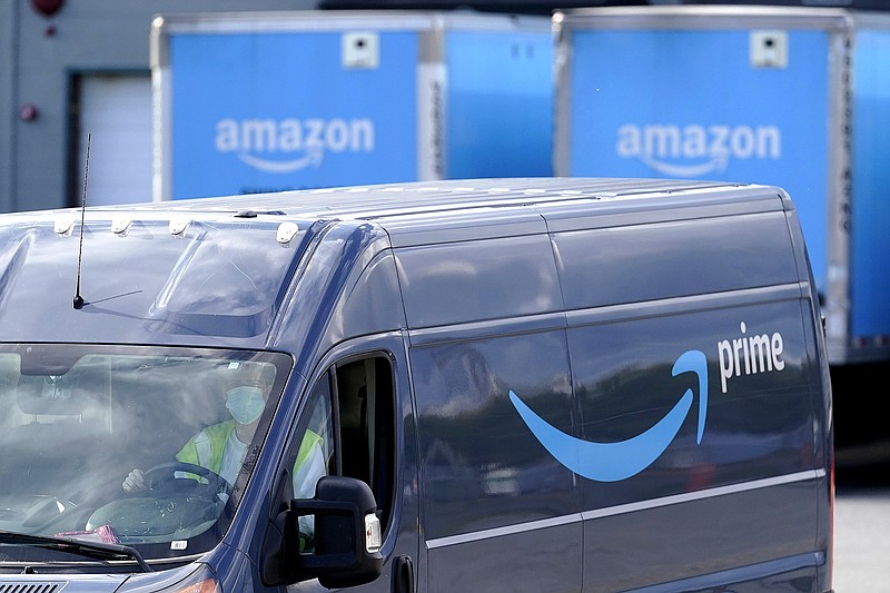 An Amazon Prime logo appears on the side of a delivery van as it departs an Amazon Warehouse location, Thursday, Oct. 1, 2020, in Dedham, Mass. Halloween is still weeks away, but retailers are hoping you'll start your holiday shopping now. The big push is coming from Amazon, which is holding its annual Prime Day sales event Tuesday, Oct. 13 and Wednesday, Oct. 14. (AP Photo/Steven Senne)