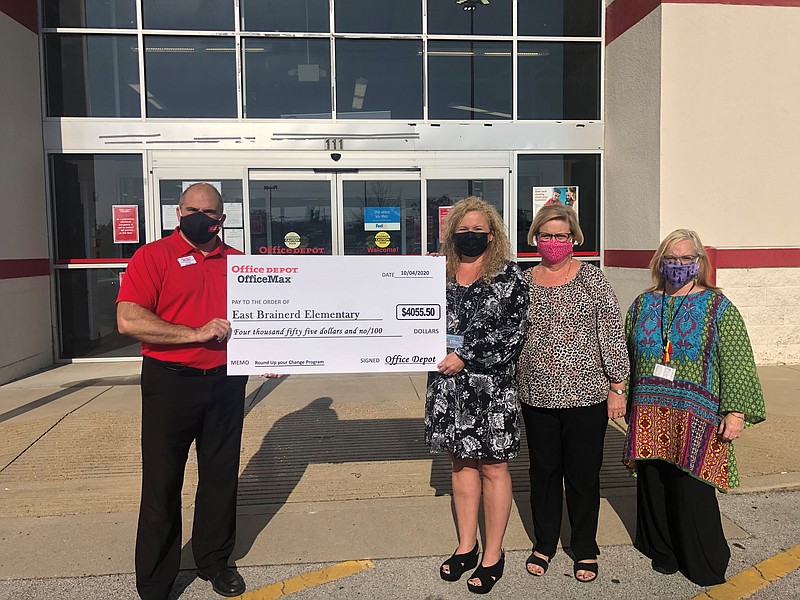 Photo courtesy of Hamilton County Schools/From left: Office Depot general manager Chuck Ayres presents a $4,055.50 check to Jane Phillips, East Brainerd assistant principal, school secretary Kay Jetton and Janie Frick the school's family partnership specialist