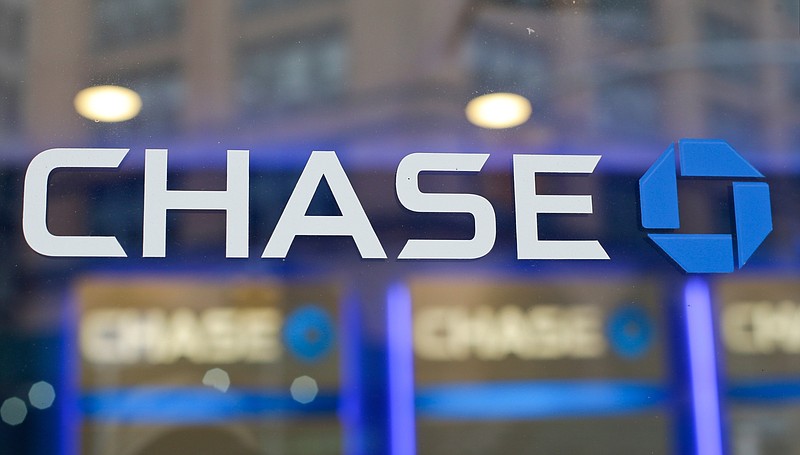 FILE - This Sept. 13, 2014, file photo, shows the Chase bank logo in New York. JPMorgan Chase says profits improved marginally in the third quarter, a notable change after the nation's largest bank had to set aside billions in the last two quarters to cover losses from the coronavirus pandemic. The New York-based bank said it earned a profit of $9.44 billion, or $2.92 a share, in the July to September period. (AP Photo/Frank Franklin II, File)