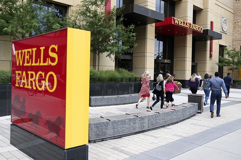 FILE - In this July 10, 2019, photo a Wells Fargo building is shown in downtown Minneapolis. Wells Fargo reported earnings of $2 billion on Wednesday, Oct. 14, 2020, less than half it made in the same period last year but a significant recovery from last quarter, when it lost $2.4 billion. (AP Photo/Jim Mone, File)
