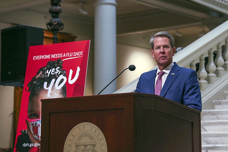 Georgia Gov. Brian Kemp speaks to reporters about Georgia's COVID-19 outbreak, Wednesday, Oct. 7, 2020, at the state Capitol in Atlanta. Kemp says that Georgia is making progress in reducing coronavirus infections, but is urging people to get a flu shot in addition to practicing social distancing, wearing masks and washing hands. (Riley Bunch/The Daily Times via AP)