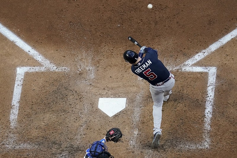 Atlanta Braves' Freddie Freeman hits a two-run home run during the fourth inning in Game 2 of a baseball National League Championship Series against the Los Angeles Dodgers Tuesday, Oct. 13, 2020, in Arlington, Texas.(AP Photo/David J. Phillip)