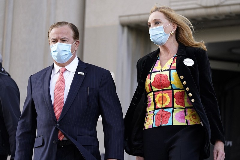 Mark and Patricia McCloskey leave following a court hearing Wednesday, Oct. 14, 2020, in St. Louis. The McCloskeys have pleaded not guilty to two felony charges, unlawful use of a weapon and tampering with evidence, after been seen waving guns at protesters marching on their private street this past summer. (AP Photo/Jeff Roberson)